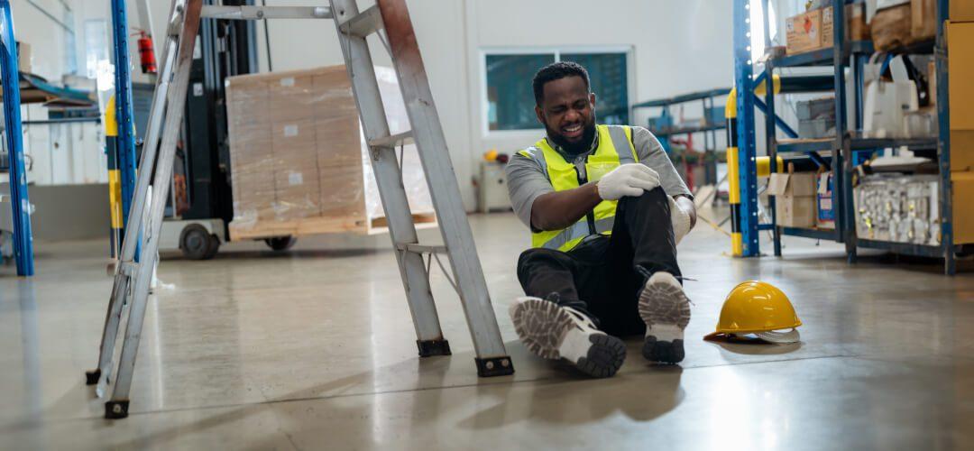 Man holding leg after falling from ladder